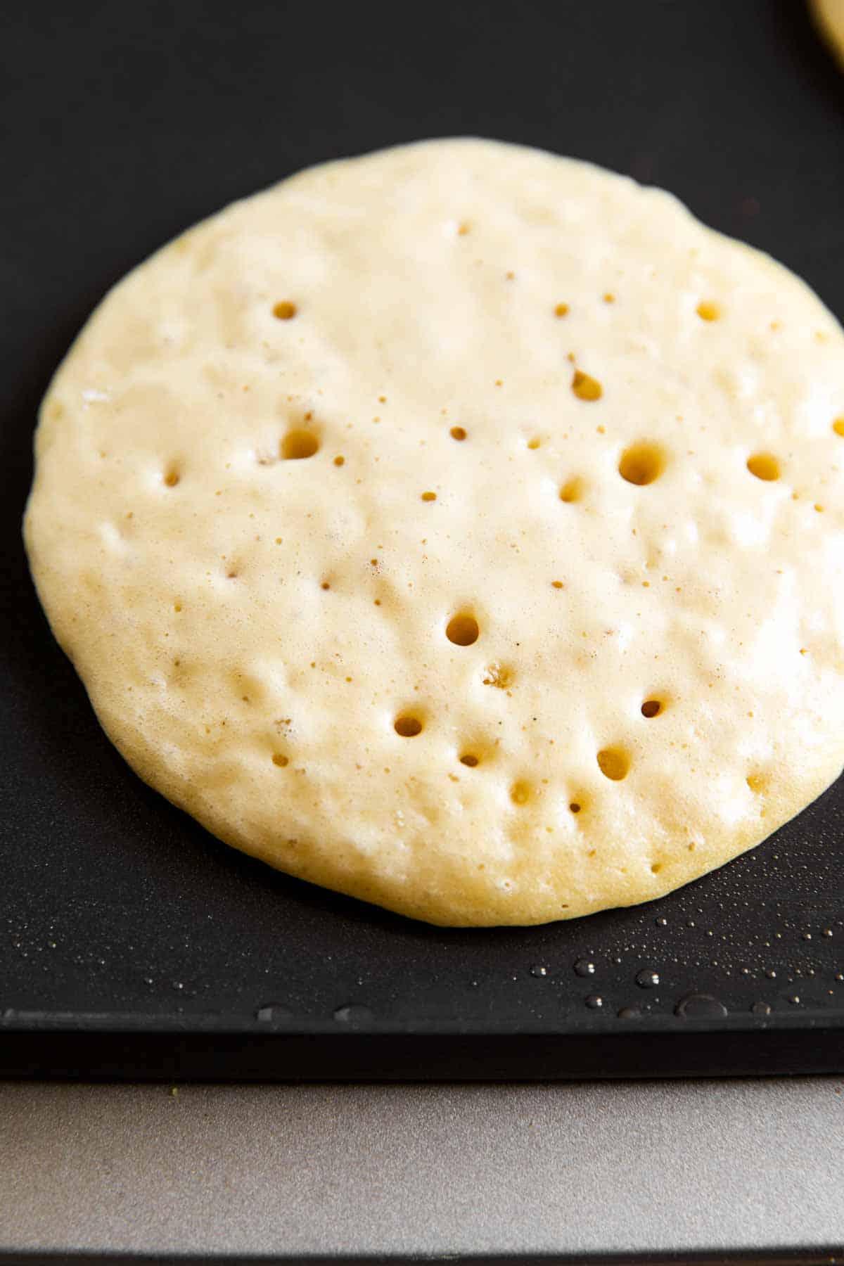 close up photo of ready to be flipped pancake on griddle