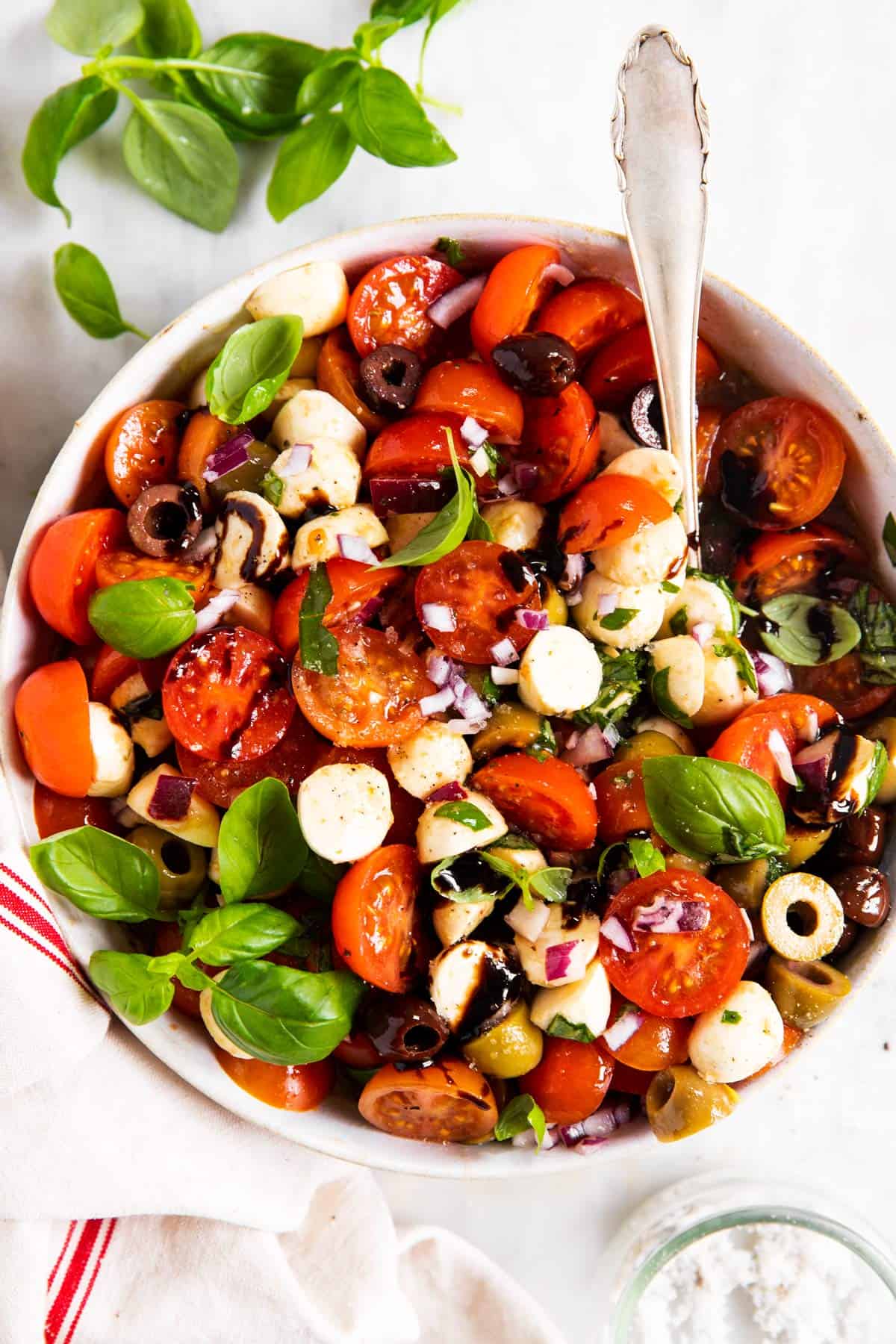 overhead view of white bowl filled with cherry tomato salad