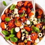 overhead view of white bowl filled with cherry tomato salad