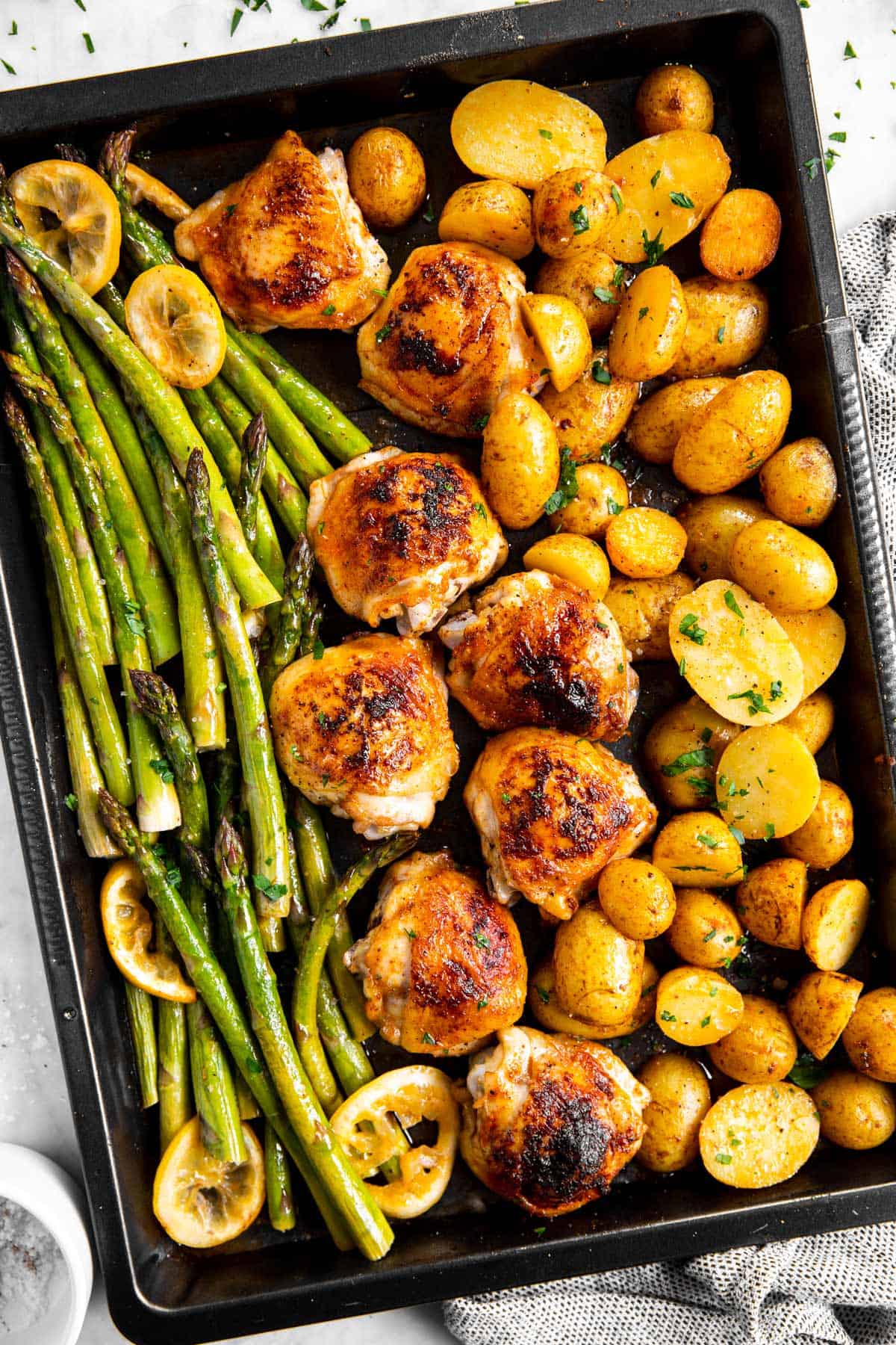 sheet pan with roasted chicken thighs, asparagus and potatoes