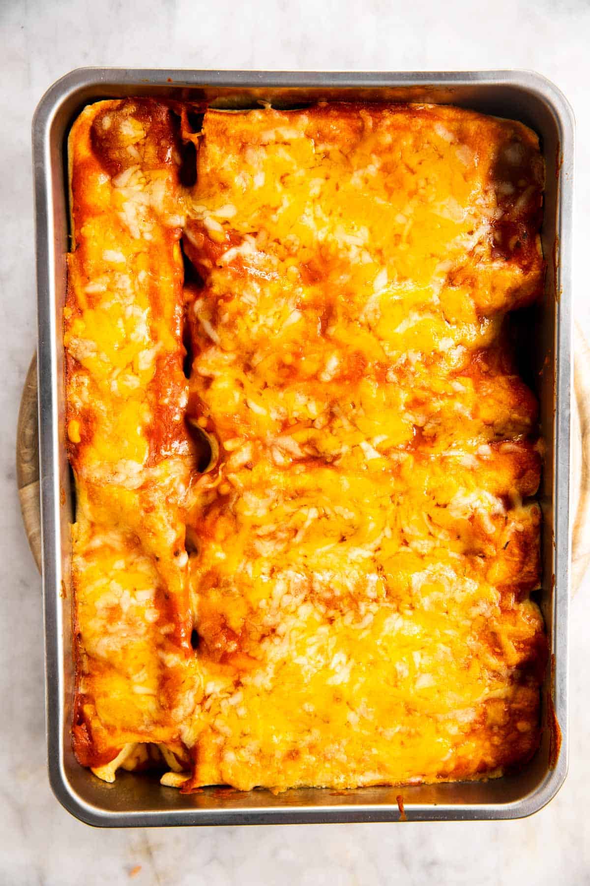 baked chicken enchiladas in casserole dish