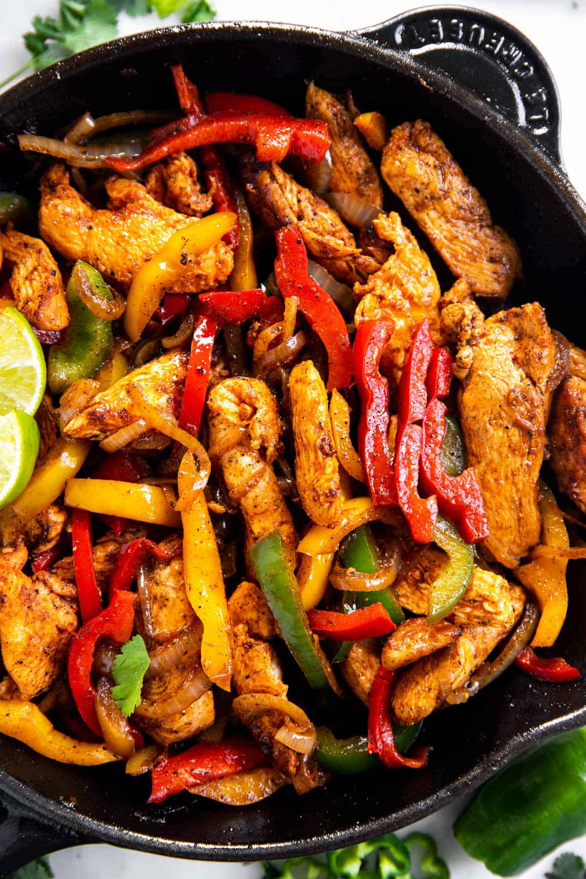 overhead close up view of chicken fajita filling in black cast iron skillet