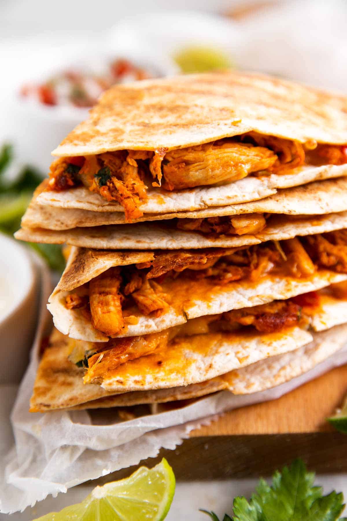 stack of chicken quesadillas on wooden board