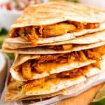 stack of chicken quesadillas on wooden board