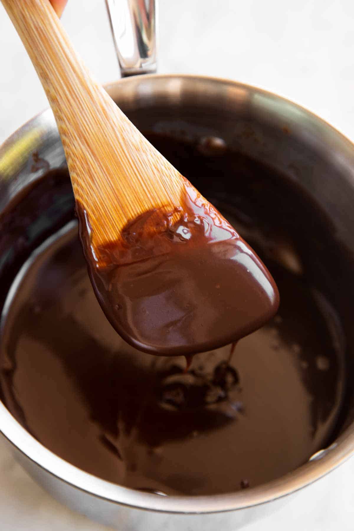 chocolate sauce on wooden spoon
