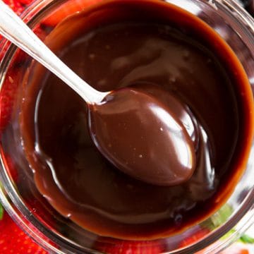 overhead view of spooning chocolate sauce from glass bowl