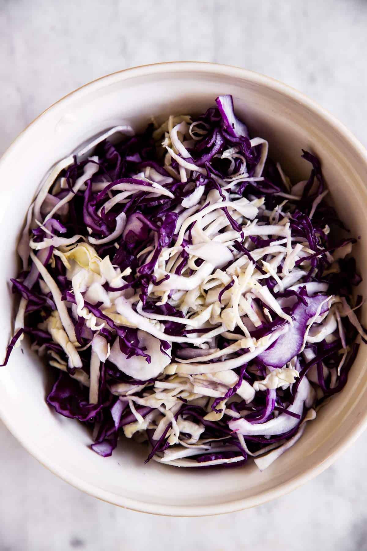 white and purple cabbage combined in large mixing bowl