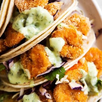 overhead view of shrimp tacos together on white plate