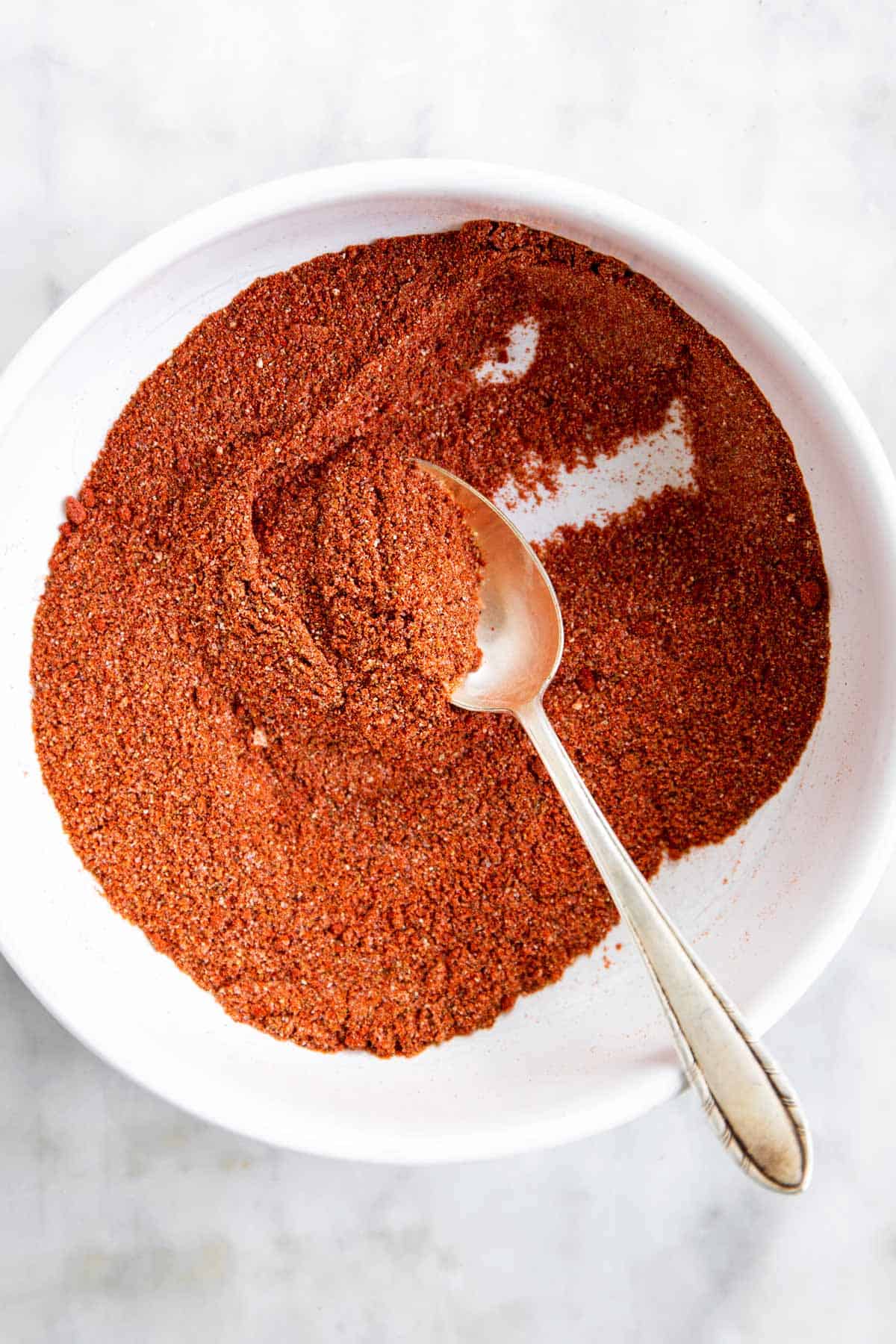 fajita seasoning in white bowl with spoon