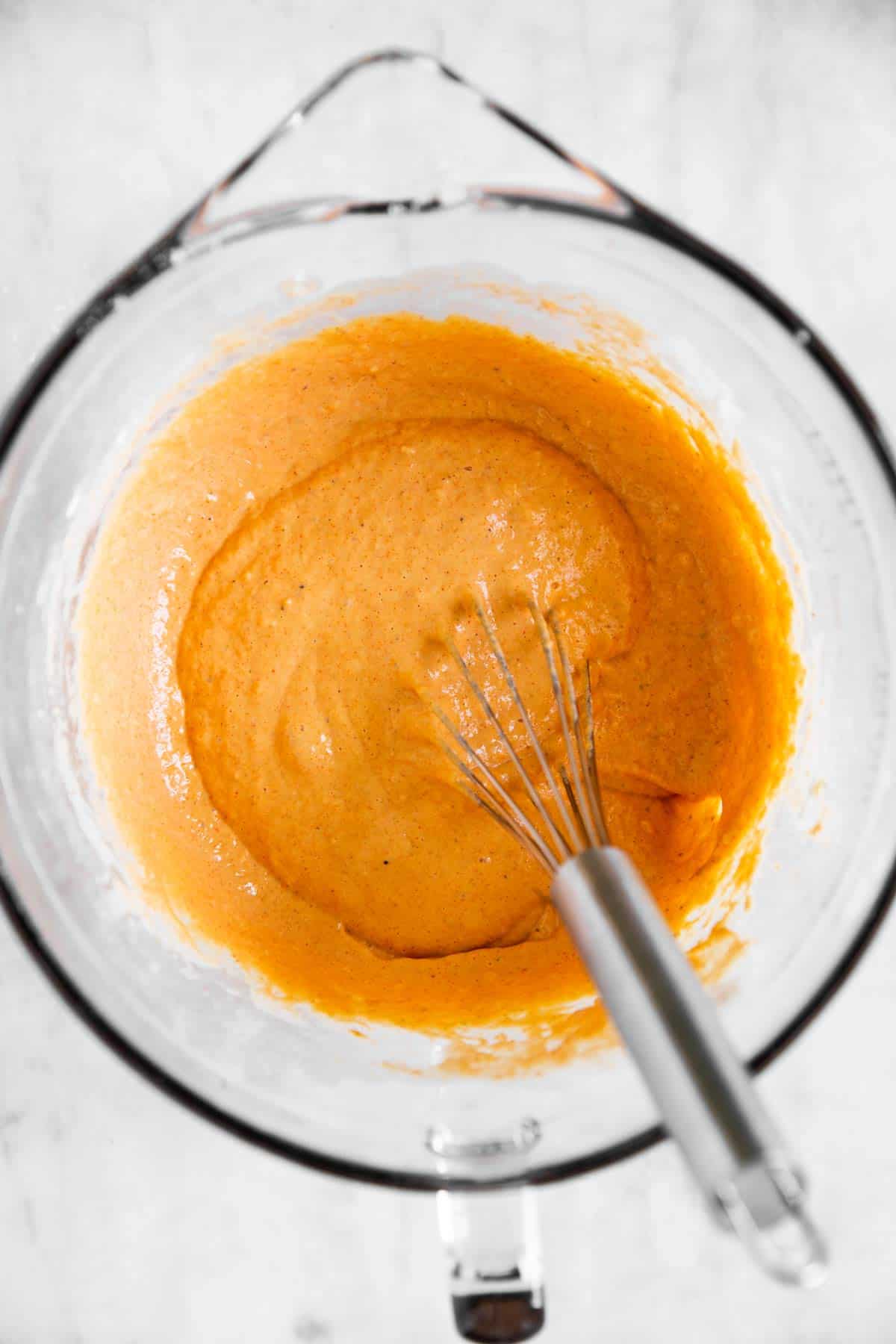 beer batter in glass bowl with metal whisk stuck in