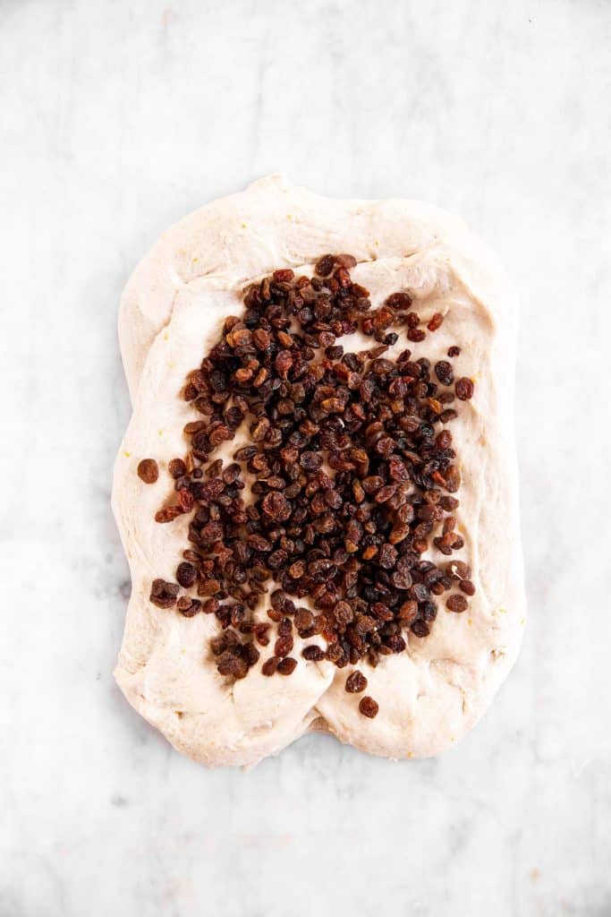 raisins spread on hot cross bun dough