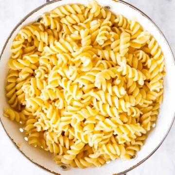 cooked pasta in white colander