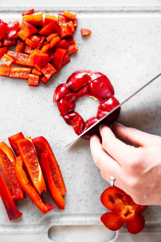 female hands slicing a bell pepper lid