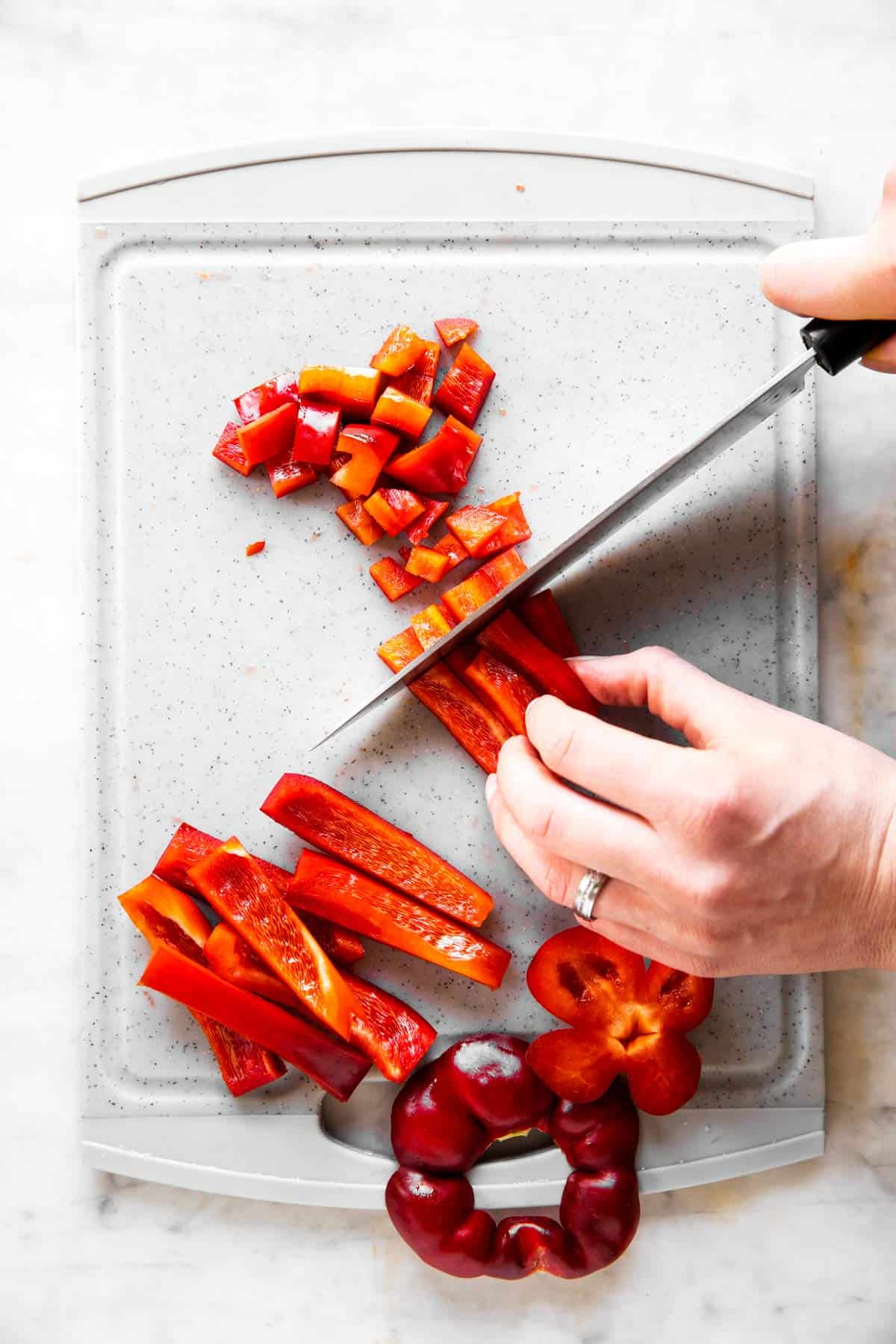 female hands dicing bell pepper