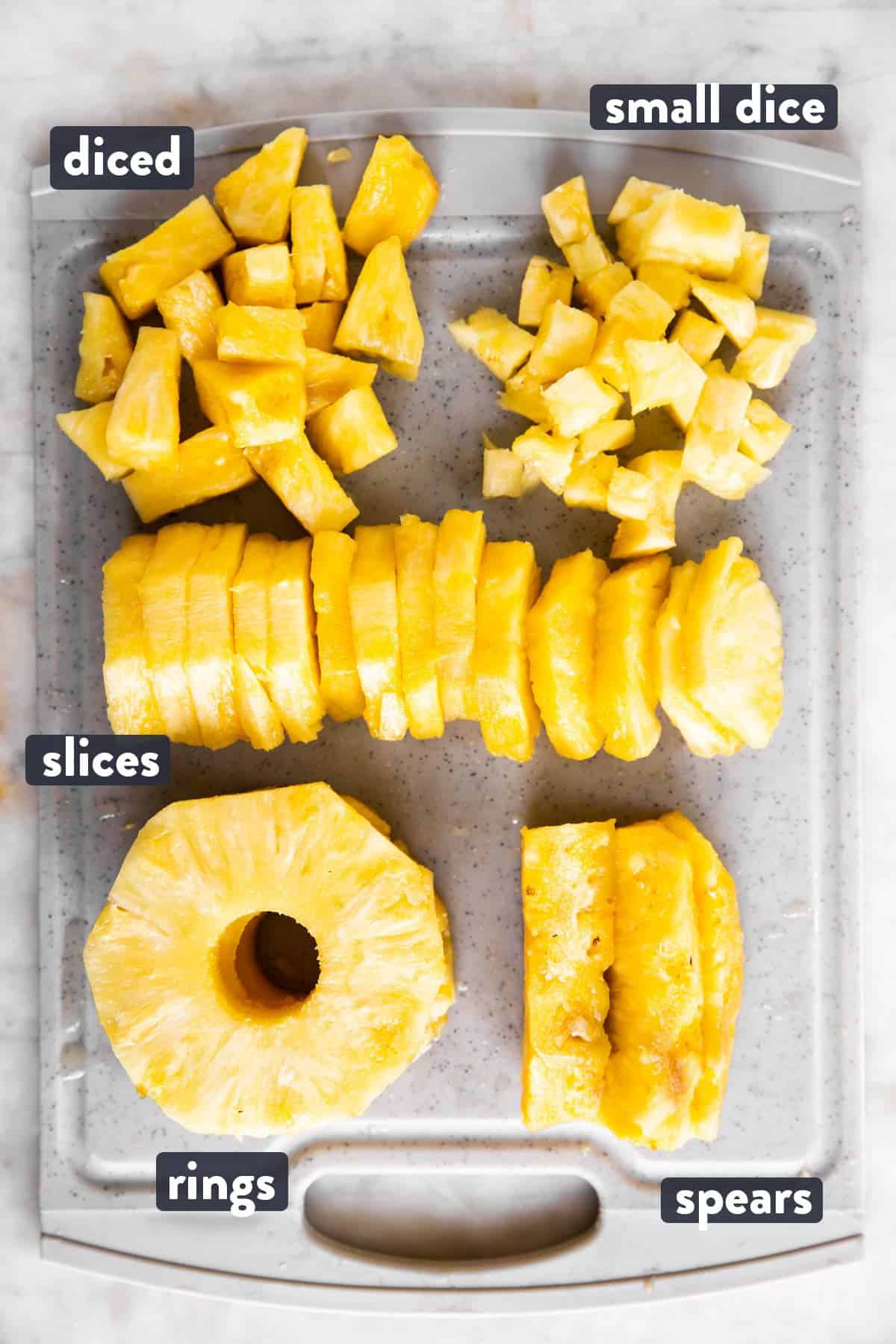 different sliced pineapple with text labels on grey chopping board