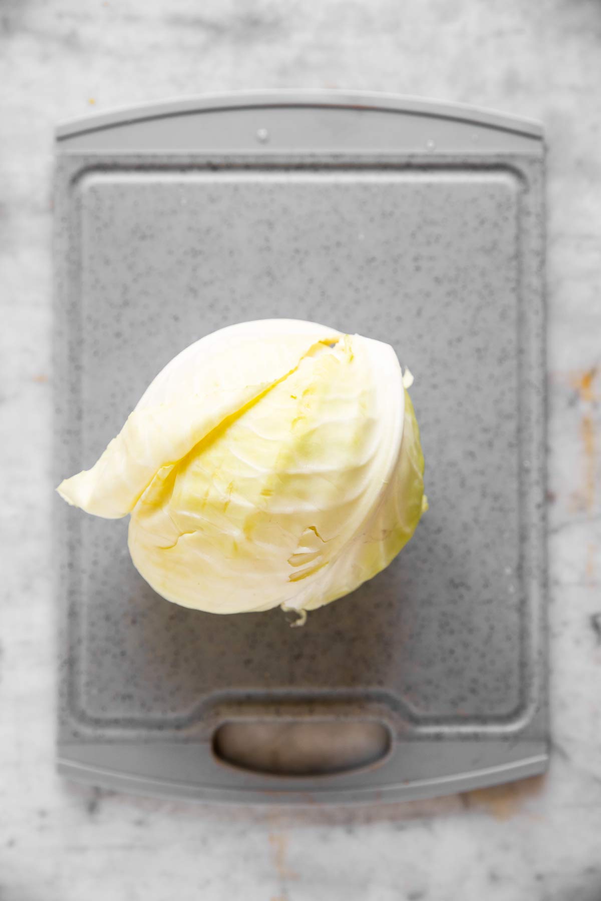 white cabbage on grey chopping board