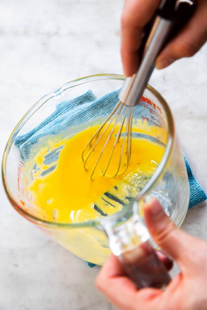 egg yolks in glass measuring jug after having been whisked