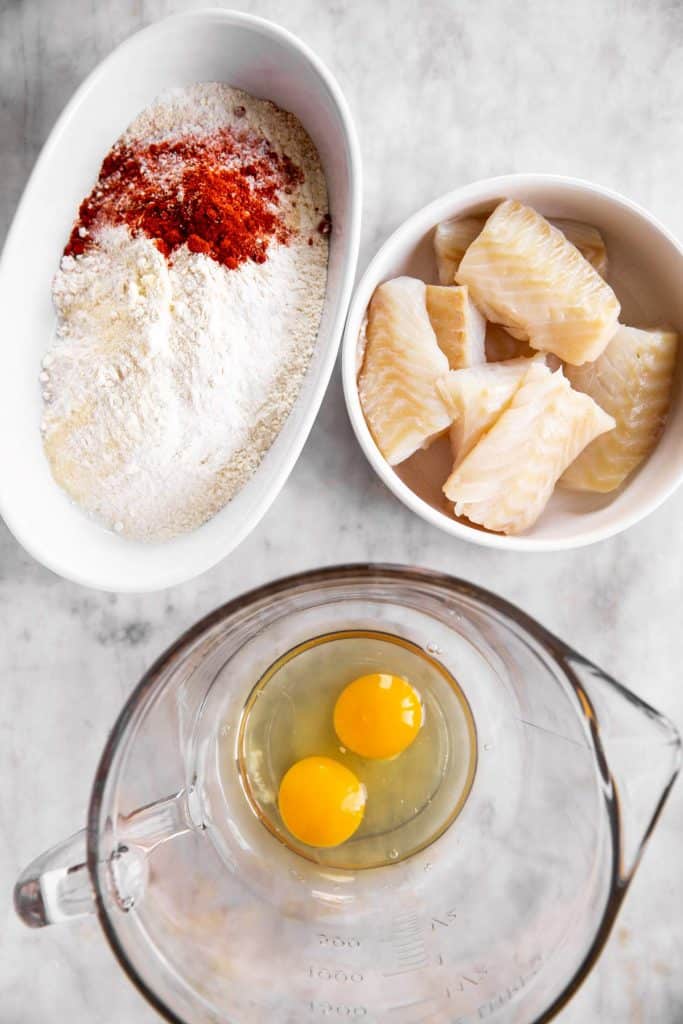 ingredients for breading fish in three bowls