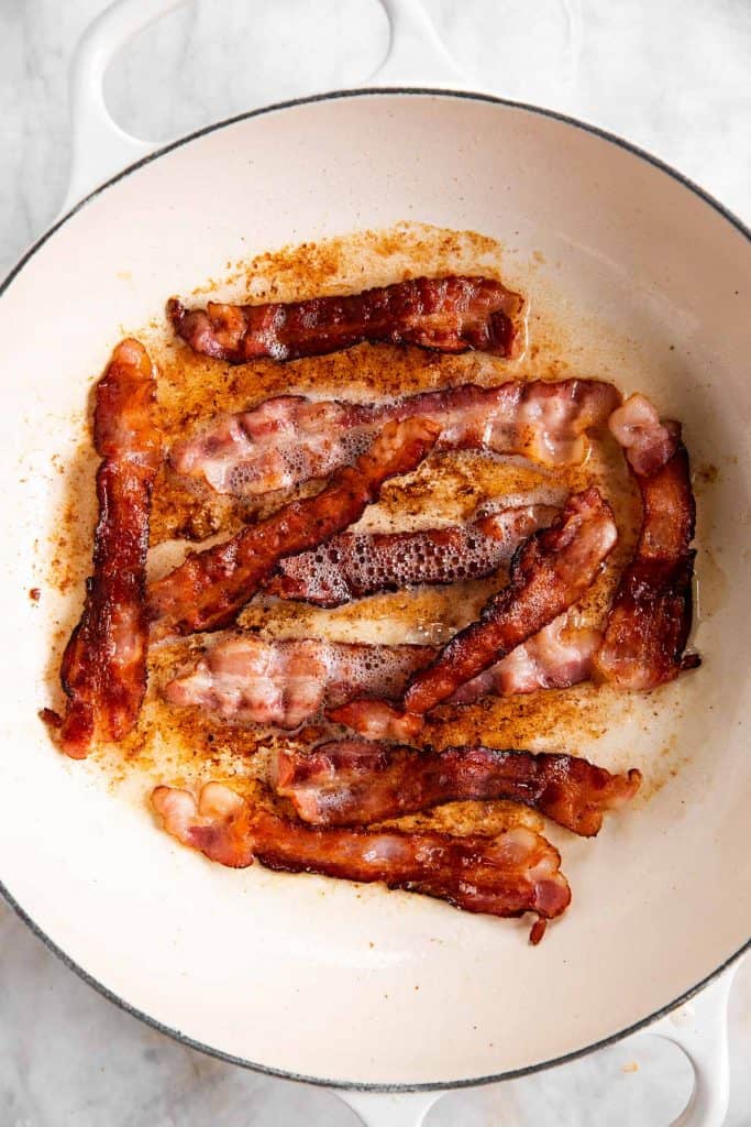 fried bacon in white cast iron skillet