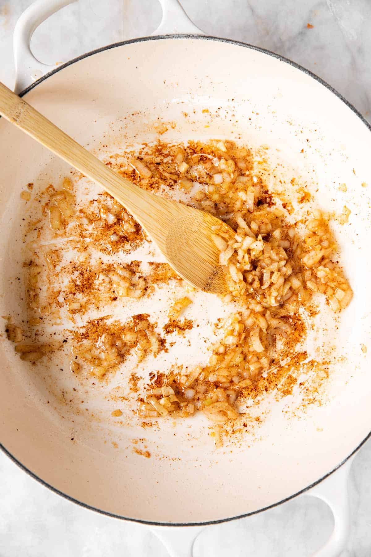 browned onion in white cast iron skillet