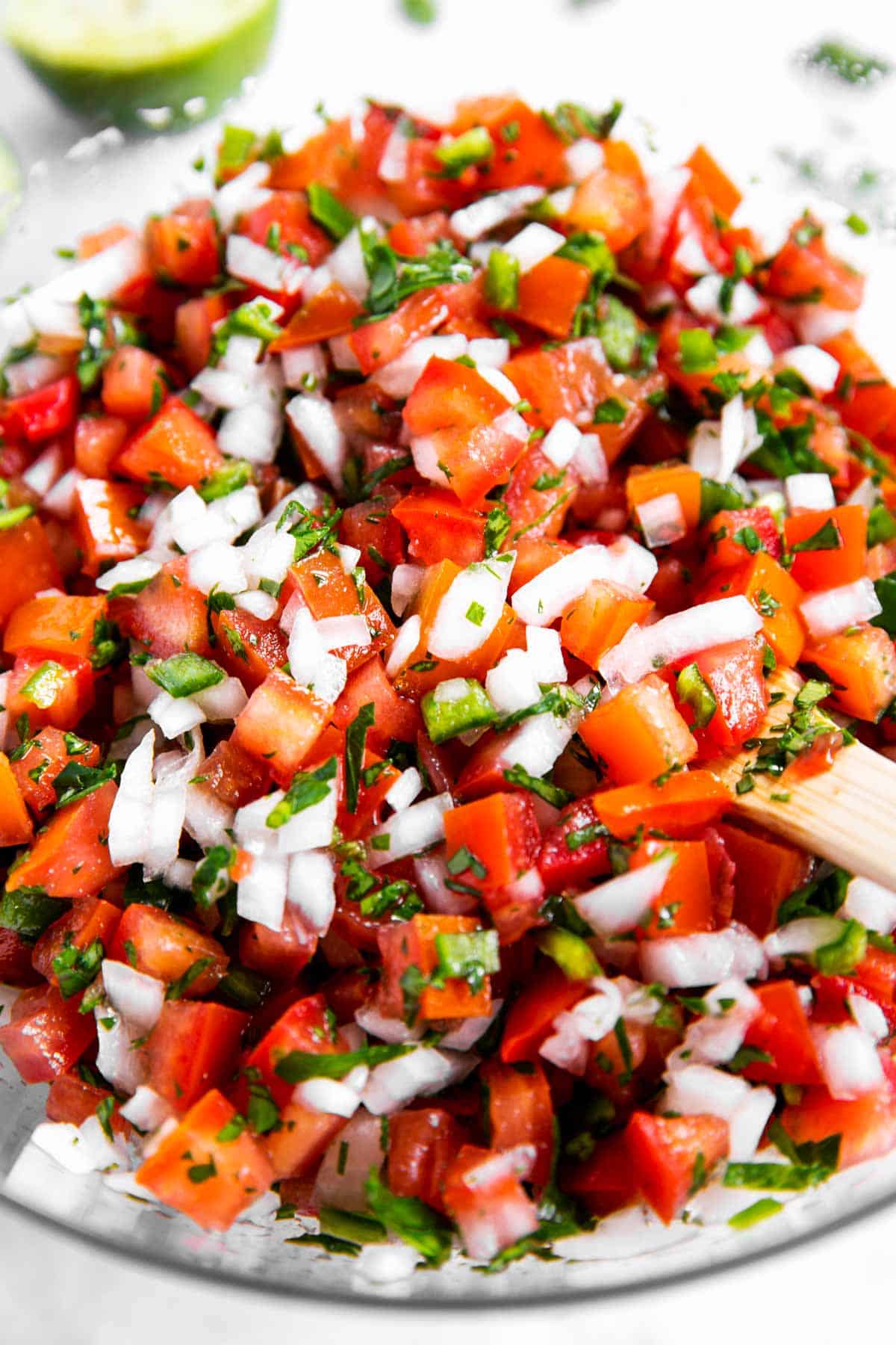 close up photo of homemade pico de Gallo in glass bowl