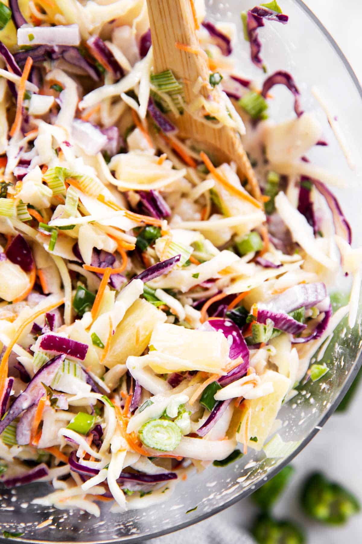 close up photo of pineapple coleslaw in glass bowl