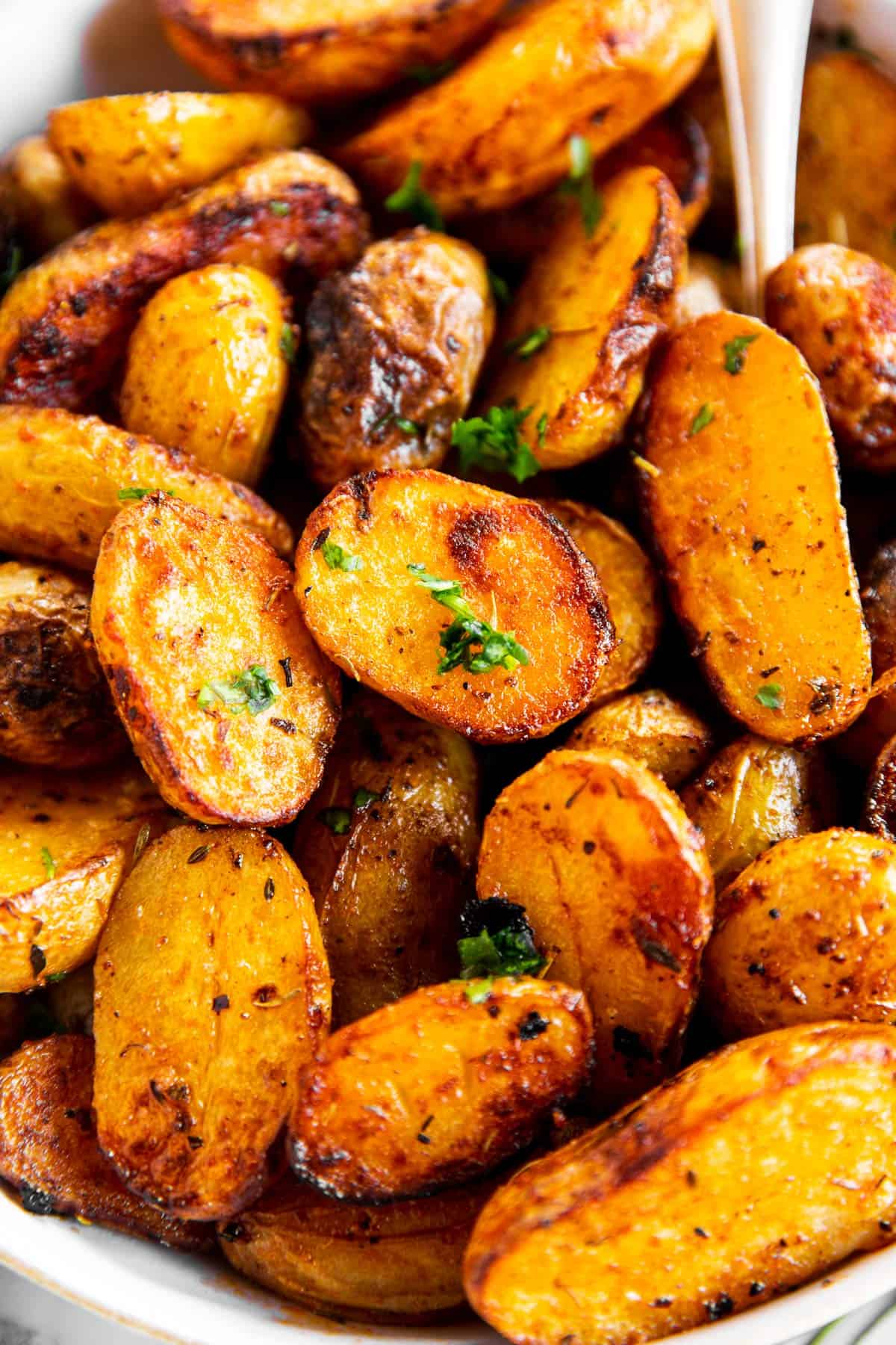 close up view of roasted baby potatoes in serving bowl