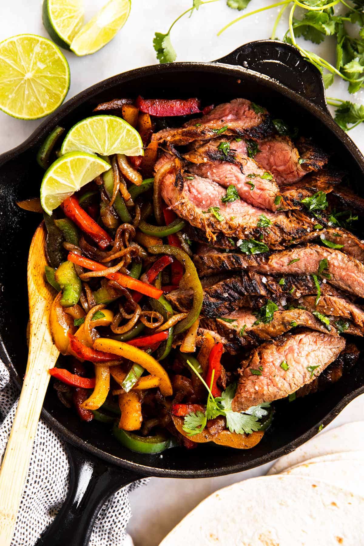 black cast iron skillet with steak fajita filling