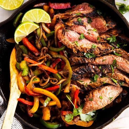 black cast iron skillet with steak fajita filling