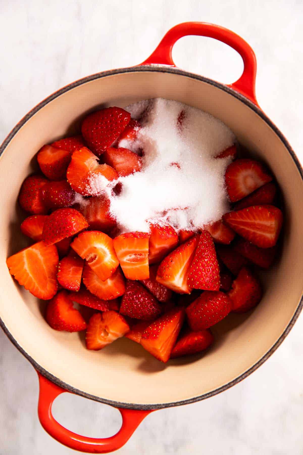 Dutch oven with strawberries and sugar