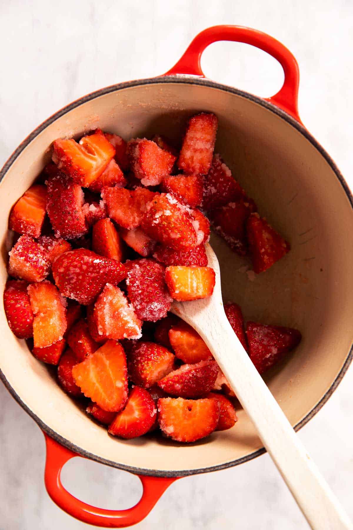strawberries combined with sugar and cornstarch slurry in Dutch oven