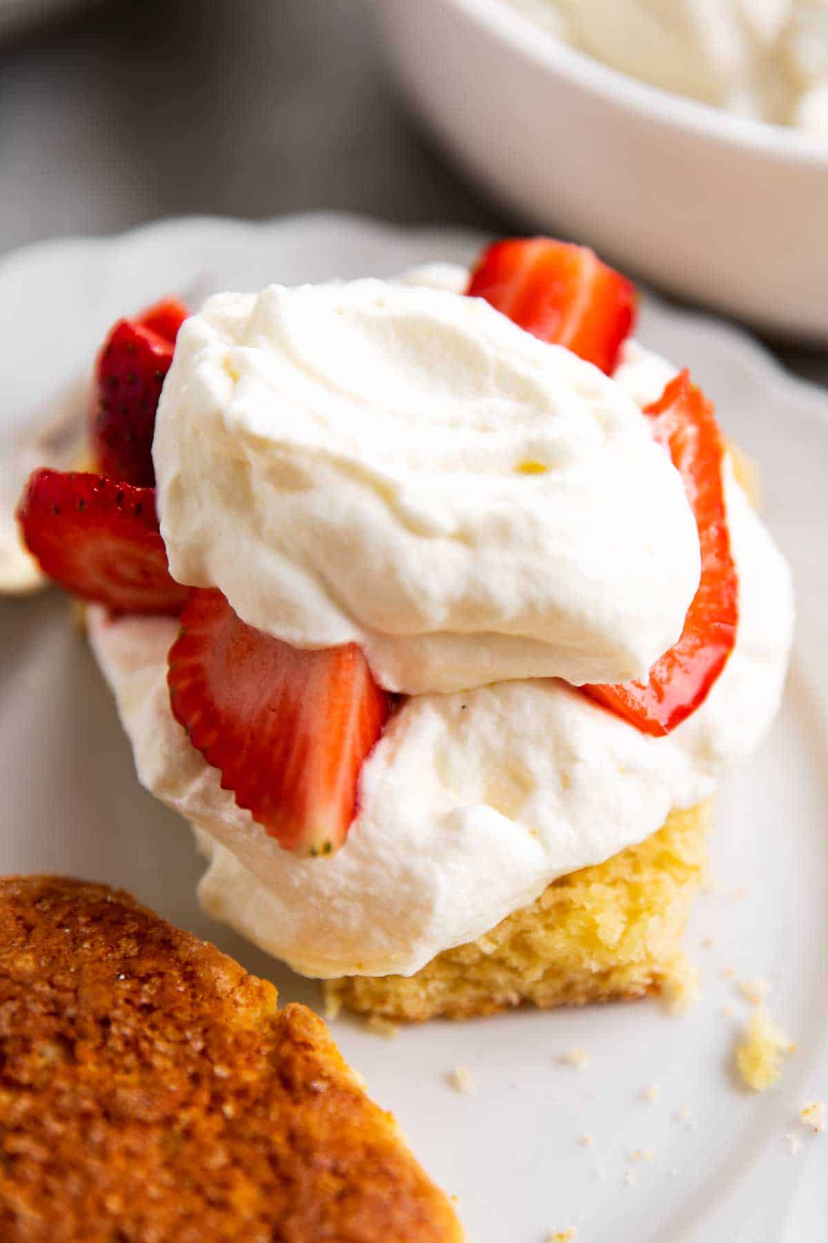 split shortcake topped with whipped cream and strawberries