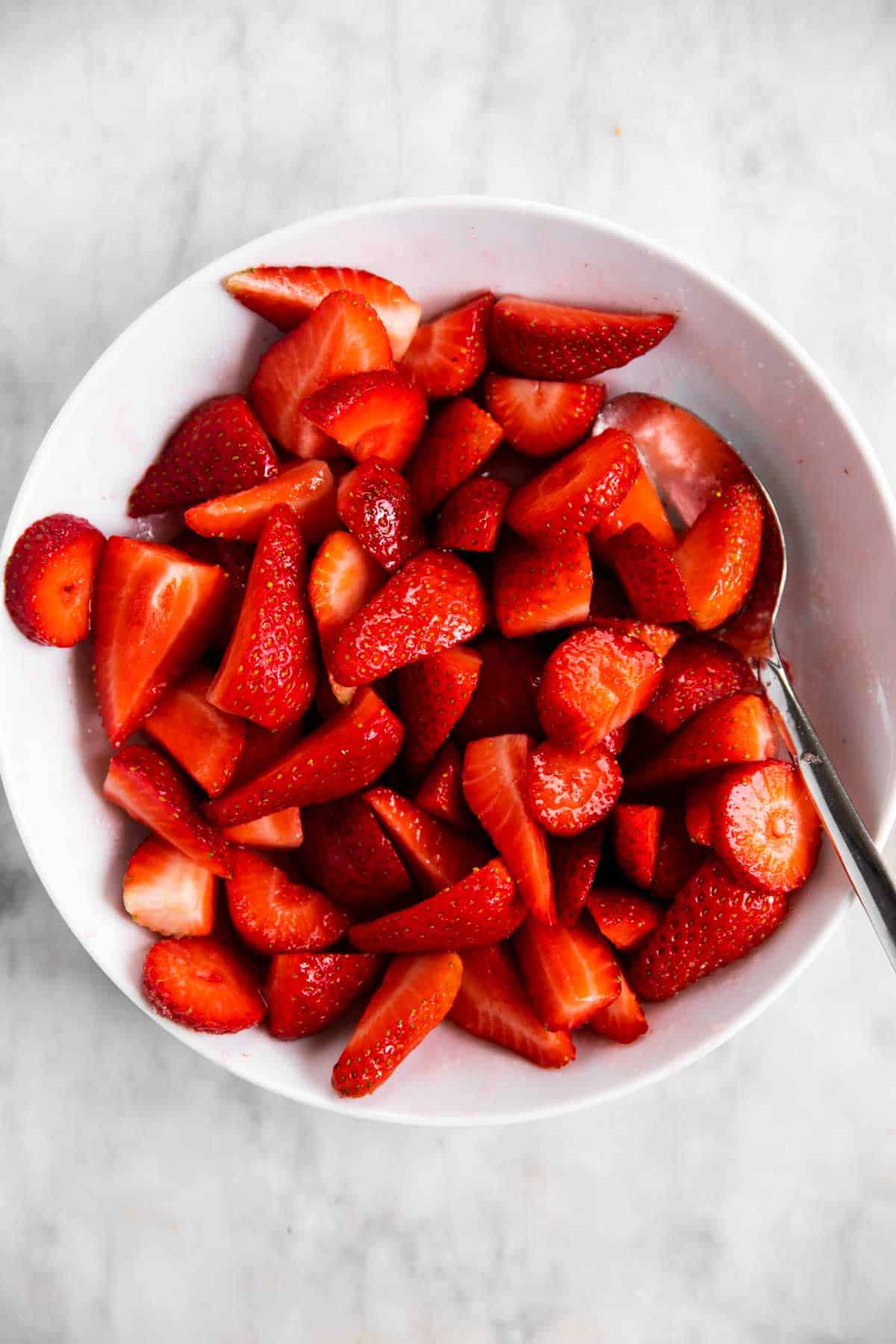 macerated strawberries in white bowl