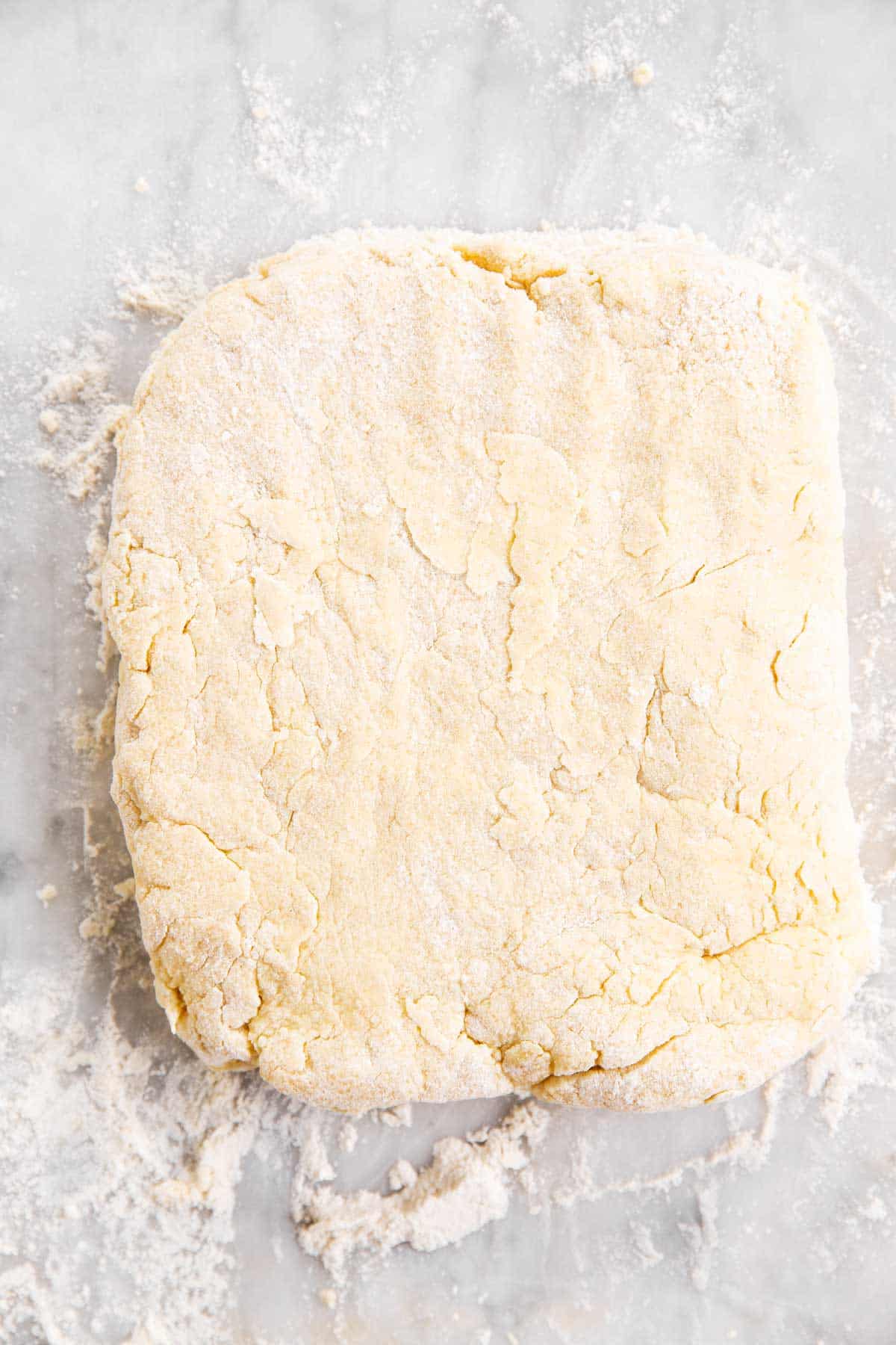biscuit dough patted into rectangle on floured marble surface
