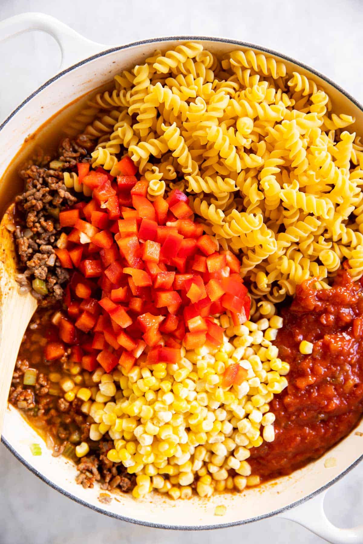 ingredients for taco pasta in white skillet