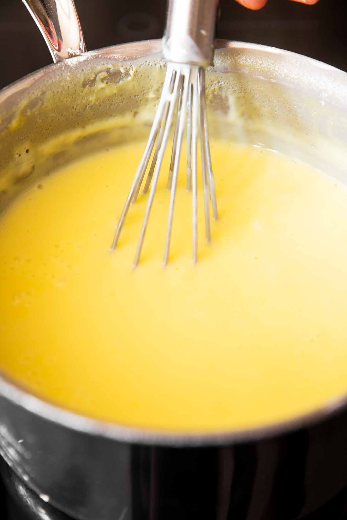 close up photo of homemade vanilla pudding in saucepan