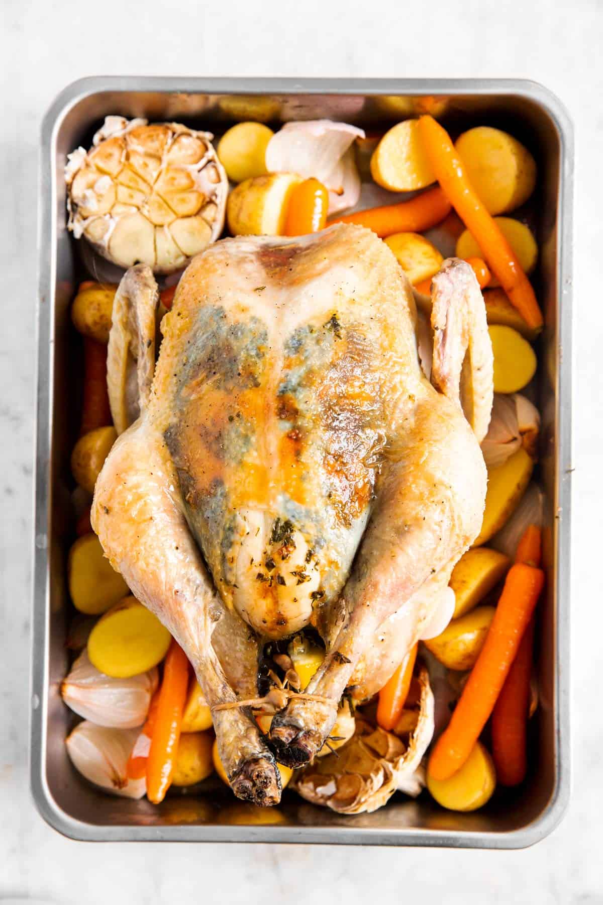 Whole Roasted Chicken Recipe - Savory Nothings 12 close up photo of roasted carrots and potatoes