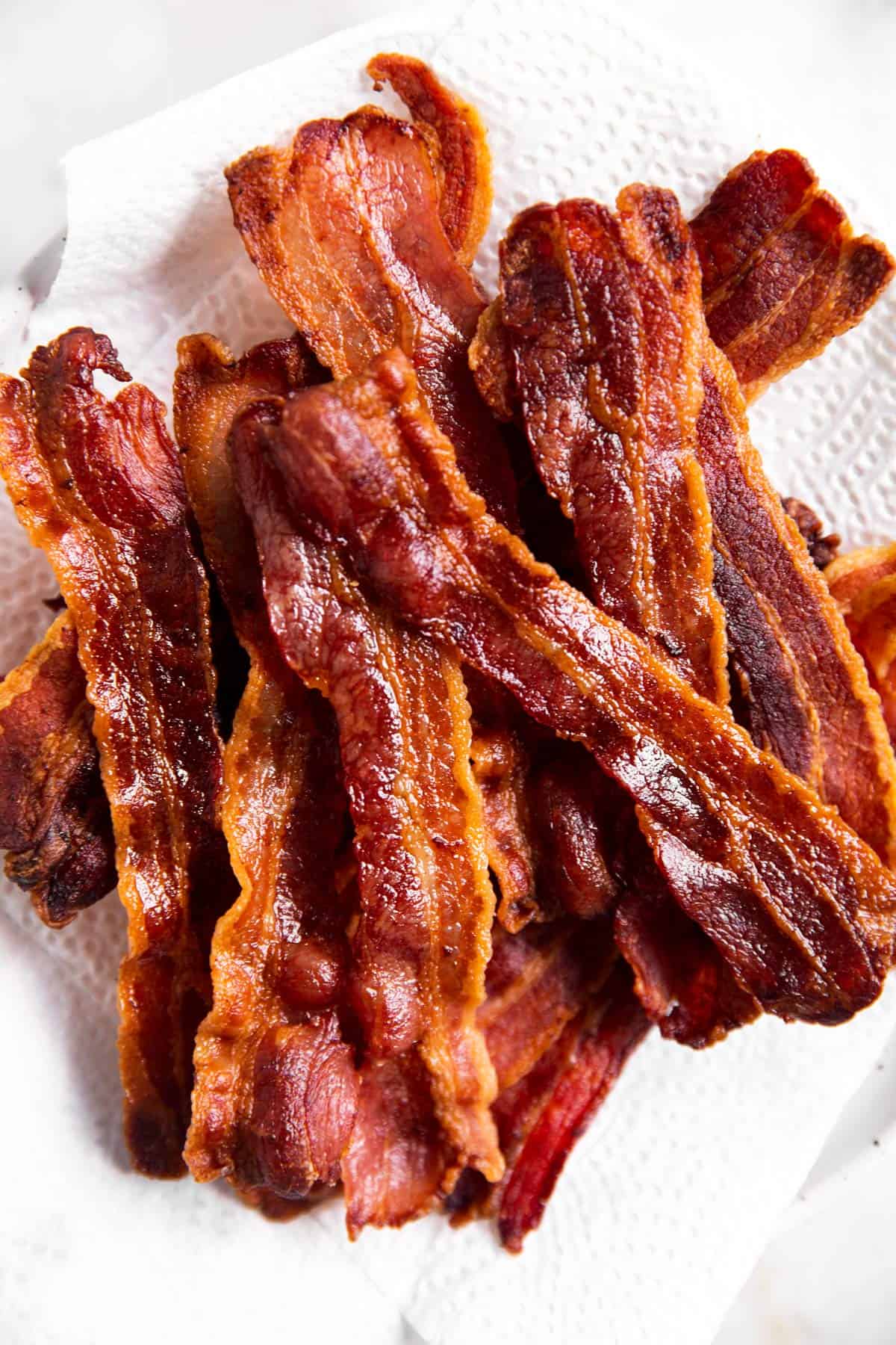 overhead view of air fried bacon on paper towel lined plate