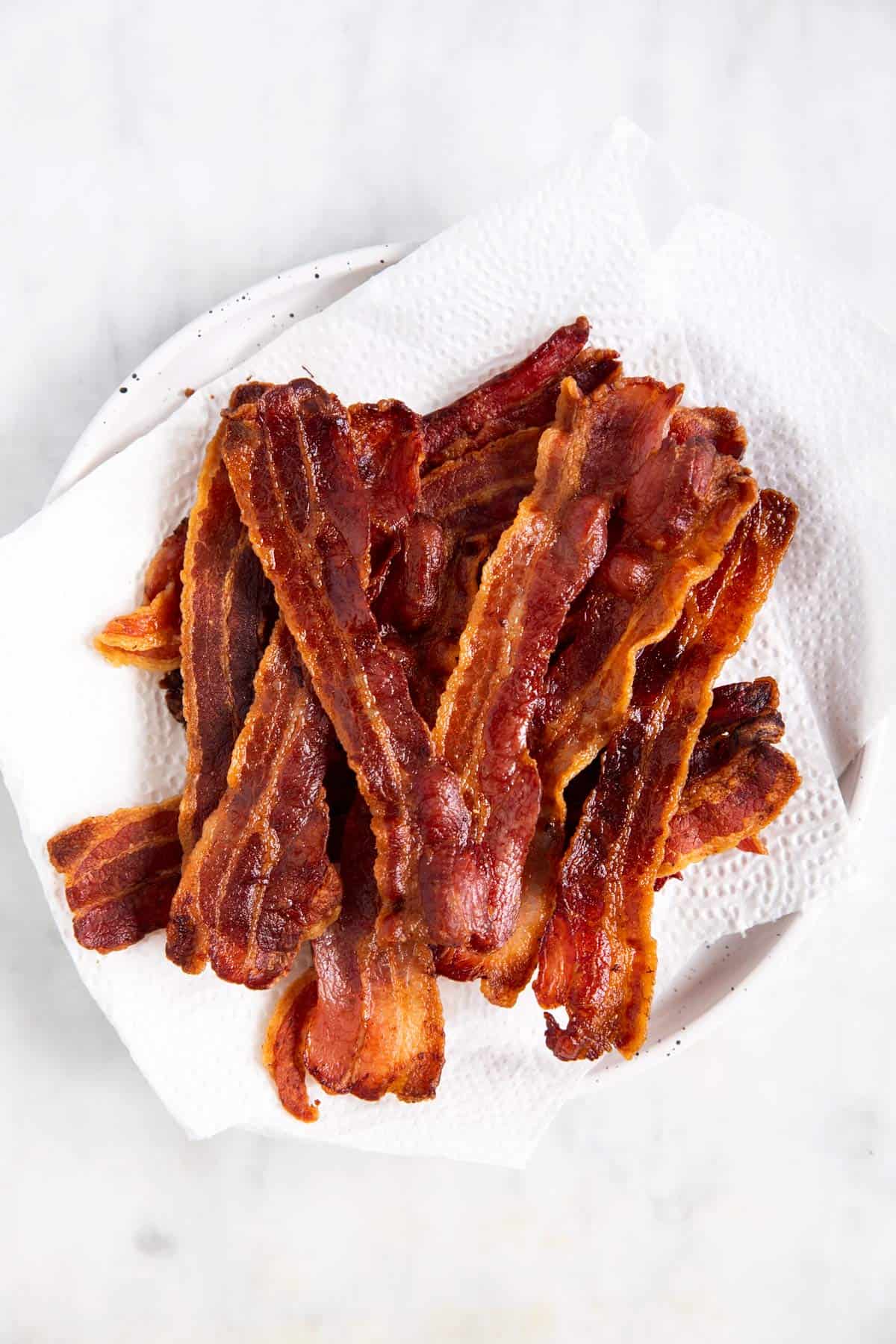 cooked bacon on paper towel lined plate