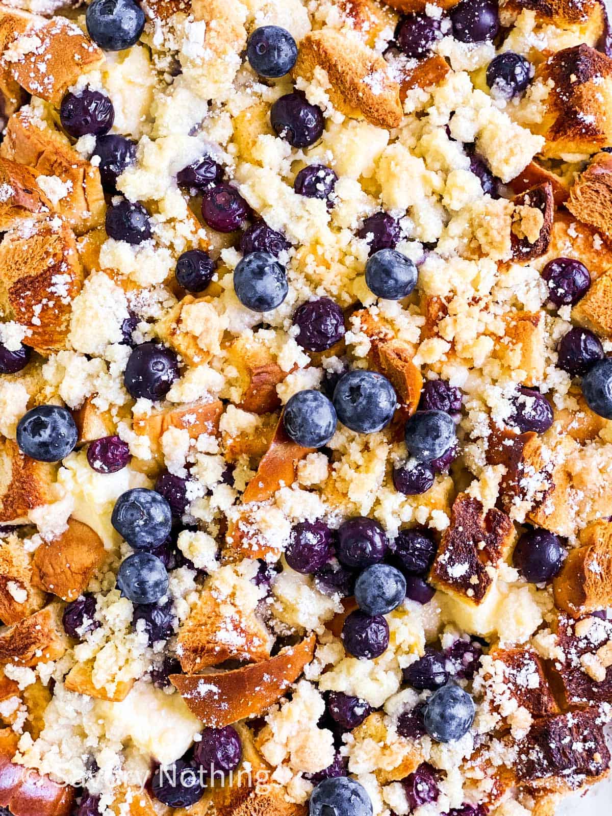 close up photo of baked blueberry French toast casserole with streusel topping