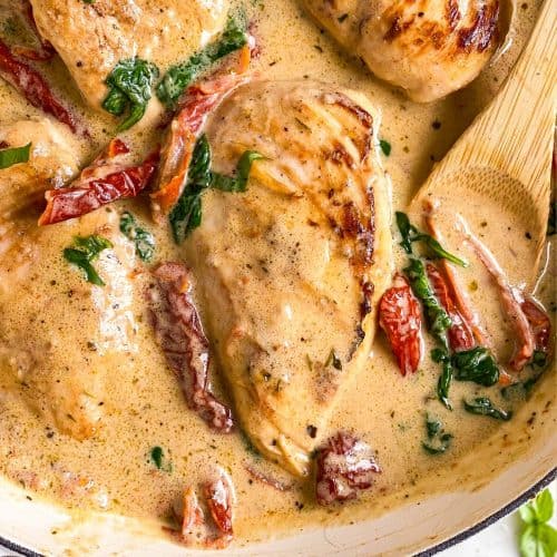 overhead close up view of creamy tuscan chicken in skillet