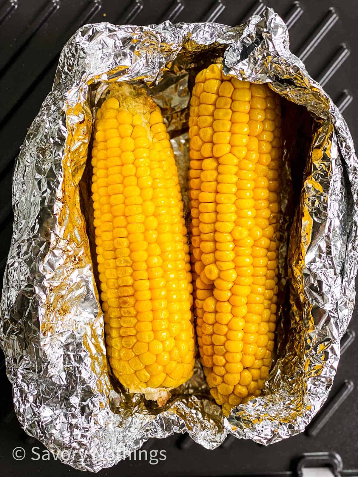 grilled corn on the cob in opened foil packet on grill