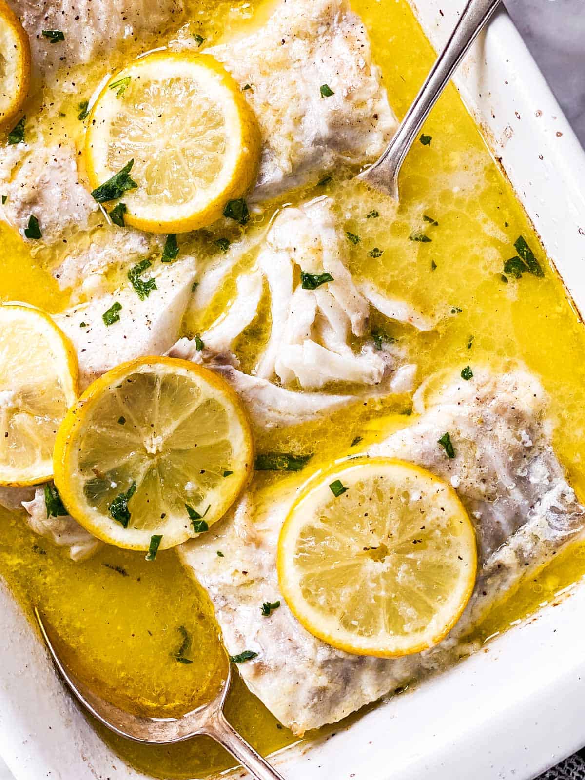 overhead view of flaked cod in lemon garlic butter sauce