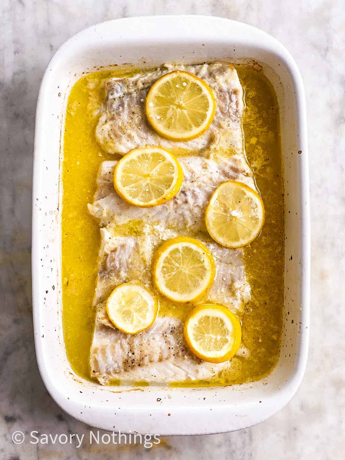 baked lemon cod in white casserole dish