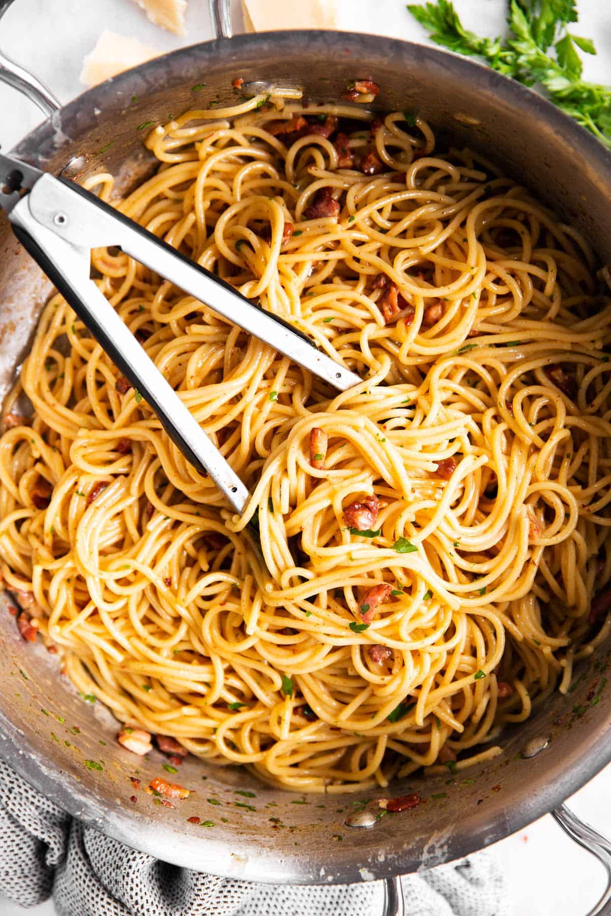 overhead view of spaghetti carbonara in stainless steel skillet