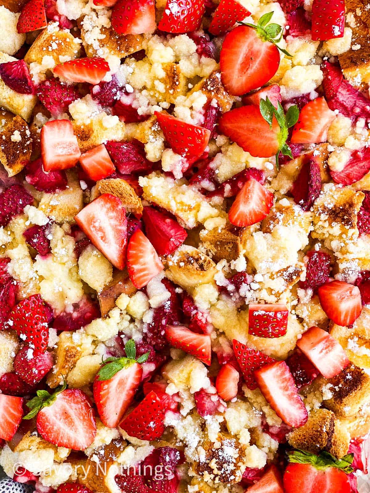 close up photo of baked strawberry French toast casserole with streusel topping