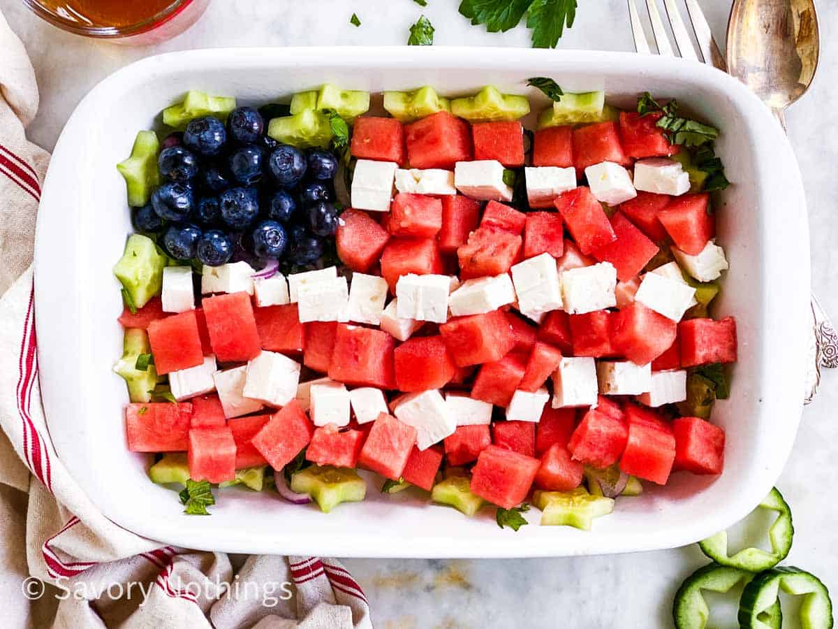 watermelon. feta cheese and blueberries arranged as American flag in rectangular white dish