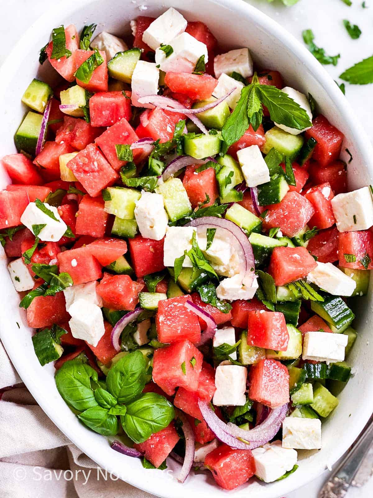 watermelon feta salad in shallow white dish