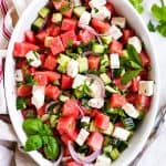 overhead view of watermelon feta salad in oval white dish