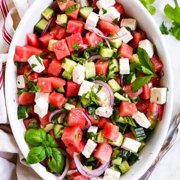 overhead view of watermelon feta salad in oval white dish